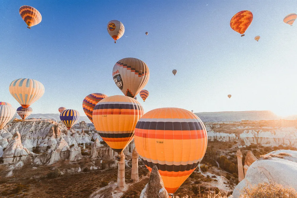 Sky full of hot-air balloons over Göreme at sunrise